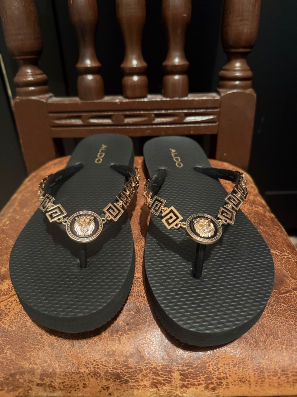 Aldo Black Flip Flops with Gold Medallion Accents